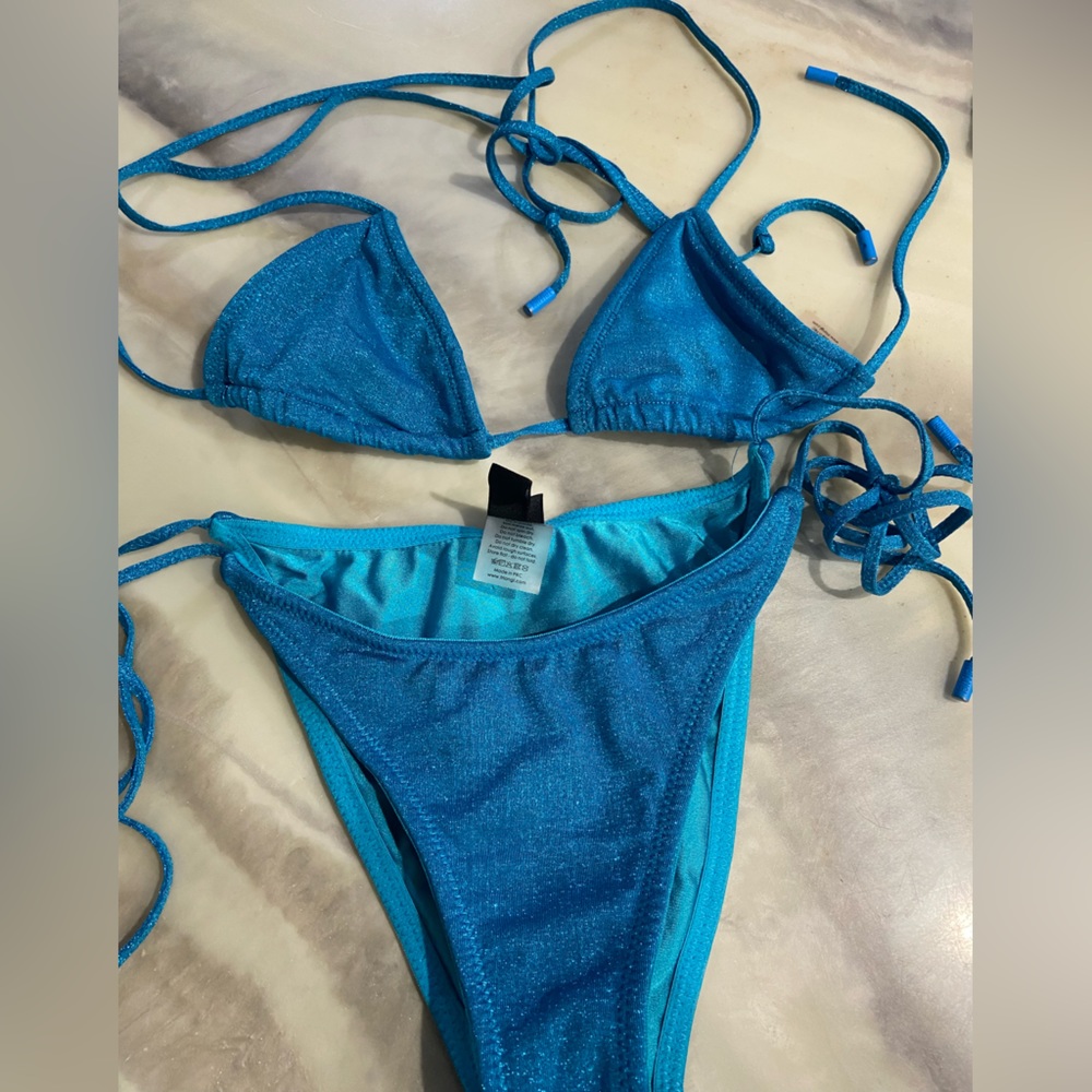 Triangle swim top is XS and bottoms are medium. Only wore a couple of times.